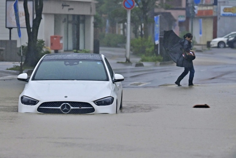 A view of a flooded road following heavy rain in Akita, northeastern Japan July 16, 2023, in this photo taken by Kyodo. Mandatory credit Kyodo/via REUTERS ATTENTION EDITORS - THIS IMAGE WAS PROVIDED BY A THIRD PARTY. MANDATORY CREDIT. JAPAN OUT. NO COMMERCIAL OR EDITORIAL SALES IN JAPAN