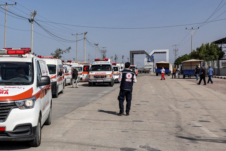 Palestinian health ministry ambulances cross the gate to enter the Rafah border crossing in the southern Gaza Strip before crossing into Egypt on November 1, 2023. - Scores of foreign passport holders trapped in Gaza started leaving the war-torn Palestinian territory on November 1 when the Rafah crossing to Egypt was opened up for the first time since the October 7 Hamas attacks on Israel, according to AFP correspondents. (Photo by MOHAMMED ABED / AFP)