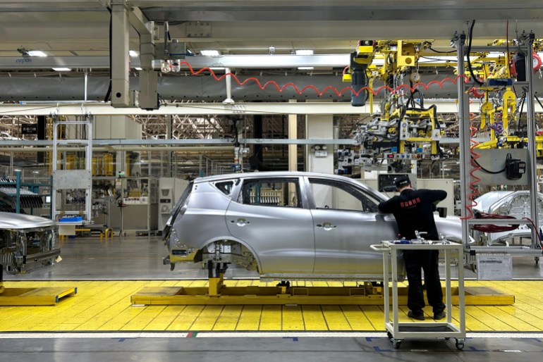 A staff member works on an assembly line manufacturing Geely's GX6 cars, at the Geely's plant in Chengdu, Sichuan province, China April 13, 2023. REUTERS/Zoey Zhang