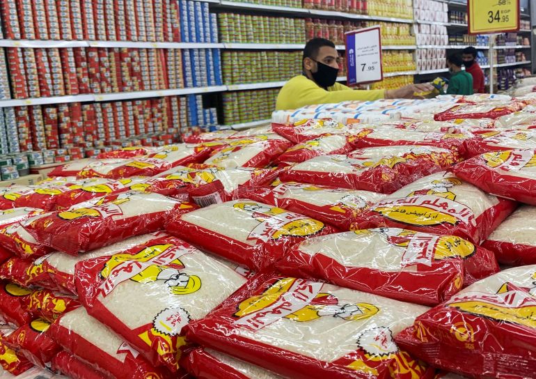 An employee wearing a protective face mask arranges packets of rice and wheat inside a Carrefour hypermarket, amid concerns over the coronavirus disease (COVID-19), in the Cairo suburb of Maadi, Egypt May 15, 2020. REUTERS/Amr Abdallah Dalsh