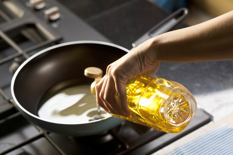 Pouring vegetable oil into frying pan