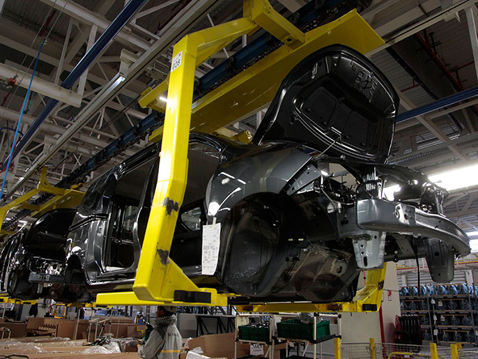 Employees work at the assembly line of Dacia Sandero cars at a factory operated by Somaca in Tangiers, February 21, 2013. Somaca is part of an expanding web of car makers and parts suppliers in Morocco, a heavily agricultural country which hopes to use the auto sector to expand its industrial base. A strong auto industry, exporting cars to Europe, North Africa and further afield, could help to resolve one of the country's main economic weaknesses, its external deficits. Morocco posted a trade deficit of $5.3 billion in the first three months of 2013, and last year obtained a $6.2 billion precautionary credit line from the International Monetary Fund in case of further pressure on its foreign reserves. Picture taken February 21, 2013. To match story MOROCCO-AUTO/INDUSTRY REUTERS/Stringer (MOROCCO - Tags: BUSINESS TRANSPORT)