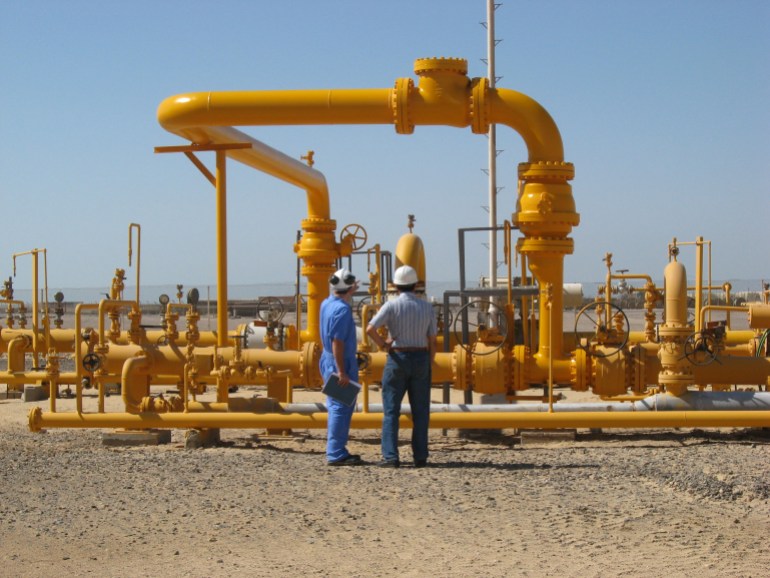 Ras Gharib, Egypt - June 04 2008: Two Engineers discussing the recently installed pipework modification in the gas production unit