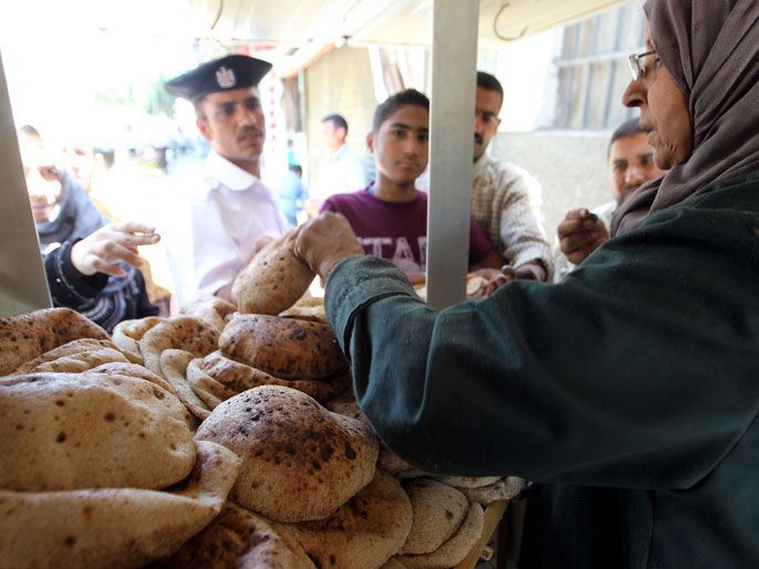 epa02745972 Egyptians stand in a queue to purchase government subsidized bread in front of a bakery in Cairo Egypt 22 May 2011. One of the Egyptian dietary staples is the traditional flat bread which is heavily subsidized by the government as about 45 per cent of the population survives with only two US dollars a day. Egypt started subsidizing staples like bread sugar and tea around World War II and has done so ever since. When it tried to stop subsidizing bread in 1977 there were riots. The bread subsidy continues costing government about $2.74 billion a year EPA/KHALED ELFIQI