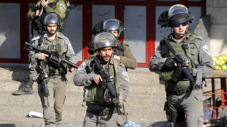 Israeli border policemen check the scence of what the Isreali Army said was a stabbing attempt by a Palestinian women at a military checkpoint in the West Bank city of Hebron, 20 December 2015. No further details were immediately available on any casualties, injureis or arrests.