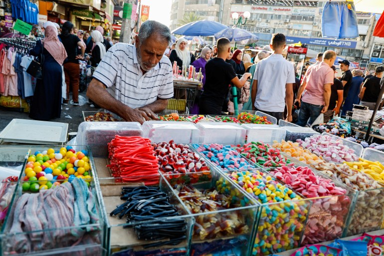 A Palestinian street vendor sells candies at a market before Eid al-Adha, in Nablus in the Israeli-occupied West Bank, June 26, 2023. REUTERS/Raneen Sawafta