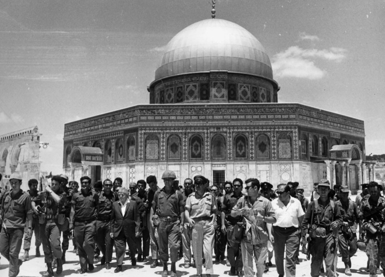 June 1967: Israeli statesmen David Ben-Gurion (1886 - 1973) and Yitzhak Rabin (1922 - 1995) lead a group of soldiers past the 'Dome of the Rock' on the Temple Mount, on a victory tour following the Six Day War, Old Jerusalem, Israel. (Photo by Hulton Archive/Getty Images)