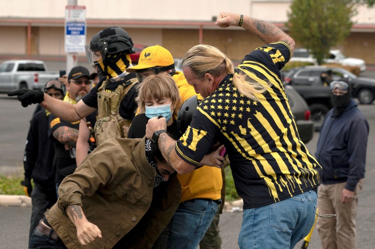 FILE PHOTO: Members of the far-right Proud Boys clash with counter-protesters during rival rallies in Portland, Oregon, U.S., August 22, 2021. REUTERS/David Ryder/File Photo