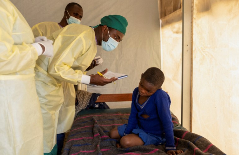 FILE PHOTO: Dr. Tresor Wakilongo, verifies the evolution of skin lesions on the ear of Innocent, suffering from Mpox - an infectious disease caused by the monkeypox virus that sparks off a painful rash, enlarged lymph nodes and fever; at the treatment centre in Munigi, following Mpox cases in Nyiragongo territory near Goma, North Kivu province, Democratic Republic of the Congo رويترز