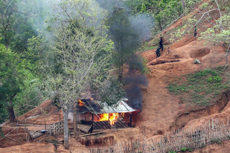 Ethnic minority Karen troops are seen after setting fire to a building inside a Myanmar army outpost