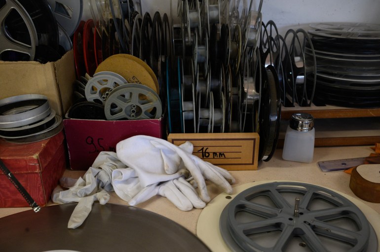 This photograph shows film equipment stacked on a desk at the Conservation and Research Center of the Toulouse Cinematheque, in Toulouse, southwestern France, on August 1, 2024. - In the early 1980s, the Palestinian Film Institute in Beirut, where around a hundred militant films were stored, was bombed by Israel during the Lebanon war. Its director, Khadijeh Habashneh, fled the country, leaving the reels behind. Almost 40 years later, the 79-year-old former director of the Institute has managed to collect 40 short and medium-length films, in 16 and 30 mm formats, which will be shown to the general public at the Cine Palestine festival in Toulouse. (Photo by Ed JONES / AFP)