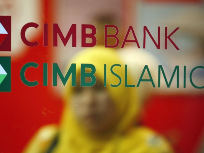 A customer leaves a branch of Malaysia's CIMB Bank in Kuala Lumpur in this November 16, 2009 file photo. As Islamic finance expands 15-20 percent a year and enters new markets from Australia to South Africa, so the need has grown for more sharia advisers who can structure financial transactions according to Islamic rules that crucially include a ban on interest. The number of women sharia scholars in Malaysia has more than tripled in the last five years according to some estimates.