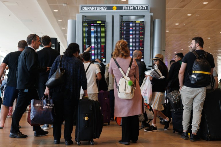 Passengers check their flight status in the departure terminal in Ben Gurion airport on the morning after a drone and missile attack from Iran, near Tel Aviv, Israel on Sunday, April 14, 2024. Israel and allies including the US, UK and France managed to mostly foil an unprecedented attack by Iran on the Jewish state. Photographer: Kobi Wolf/Bloomberg via Getty Images