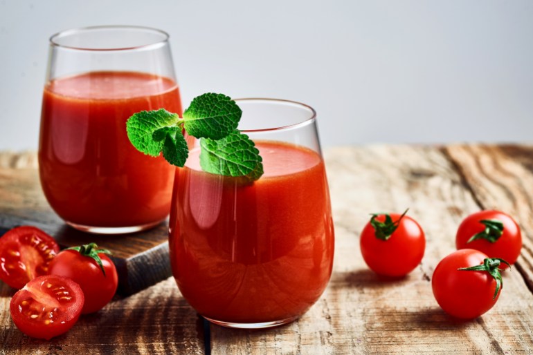 Tomato juice. Fresh red tomato detox juice in glass. Homemade tomato juice.