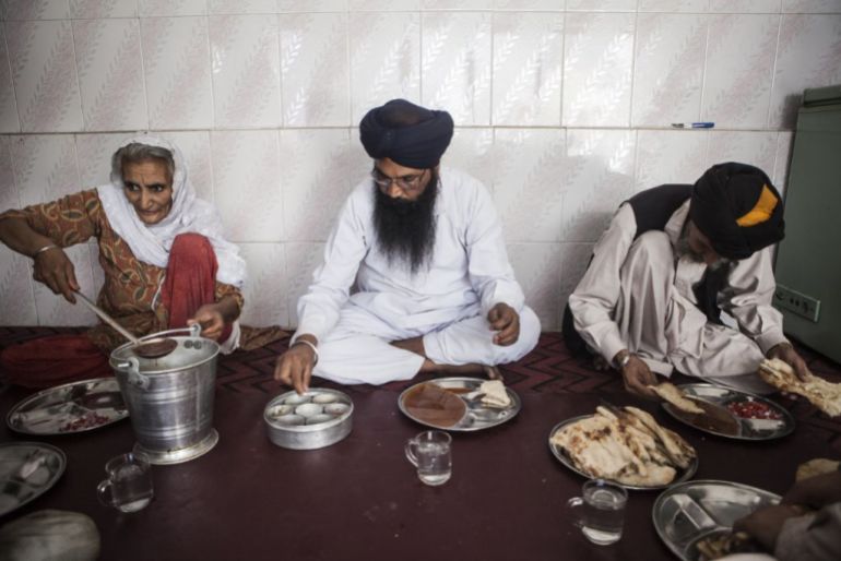 KABUL, AFGHANISTAN - JULY 25: Sikhs eat lunch at the Gurdwara Sri Guru Singh Sabha, a Sikh temple in the Kart-e-Parwan neighborhood of Kabul Afghanistan, July 25, 2012. The Sikh community in Afghanistan, which arrived several hundred years ago, has been mildly tolerated by the various powers ruling over the past few decades, however, years of war have taken their toll on the community forcing many of them to leave. What was once thousands of families are now only several hundred living in the country. (Jonathan Saruk/Getty Images)