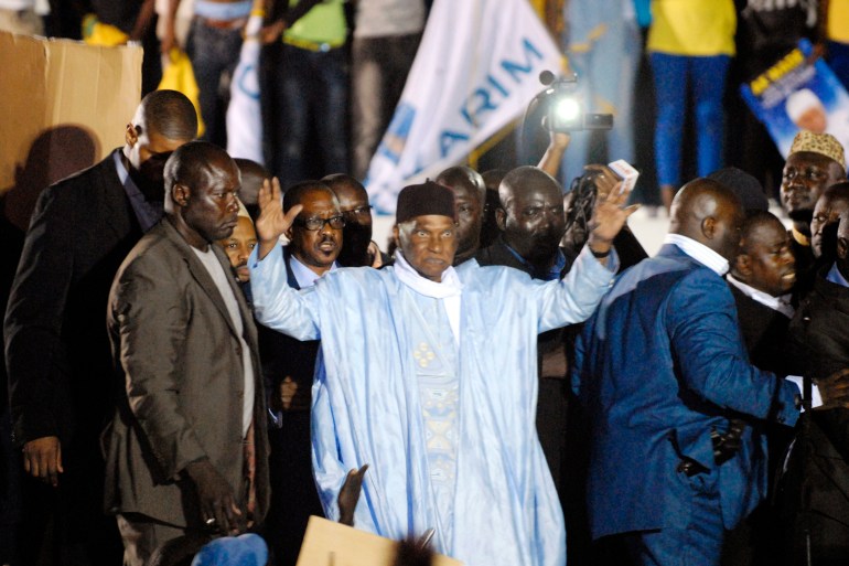 Senegal's former President Abdoulaye Wade greets a crowd upon his arrival in Dakar April 26, 2014. Wade returned to the West African country late on Friday amid tight security at the airport, two days later than planned due to flight problems that his party blamed on the government of successor Macky Sall. Wade decided to come back after authorities decided last week to press ahead with the trial of his son Karim, who face corruption charges, in June. REUTERS/Mamadou Gomis (SENEGAL - Tags: POLITICS CRIME LAW)