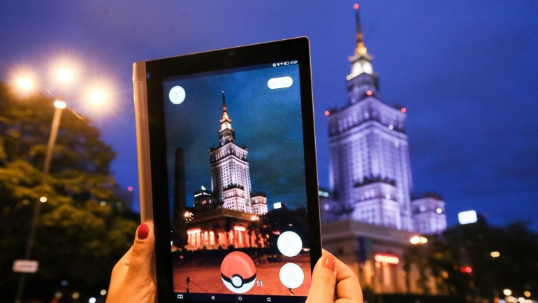 A close-up view of a gamer playing the Pokemon Go app next to the Palace of Science and Culture in Warsaw, Poland, 14 July 2016. The japanese Nintendo mobile game that uses the GPS to locate the smartphone's location, has gained a huge popularity among smartphone users and added to the value of Nintendo that partly owns the franchise enterprise that makes Pokemon. EPA/PAWEL SUPERNAK POLAND OUT