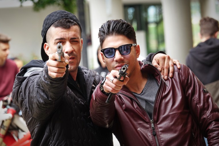 Gang members with a gun ready to shoot. Marseille, France - April 2018