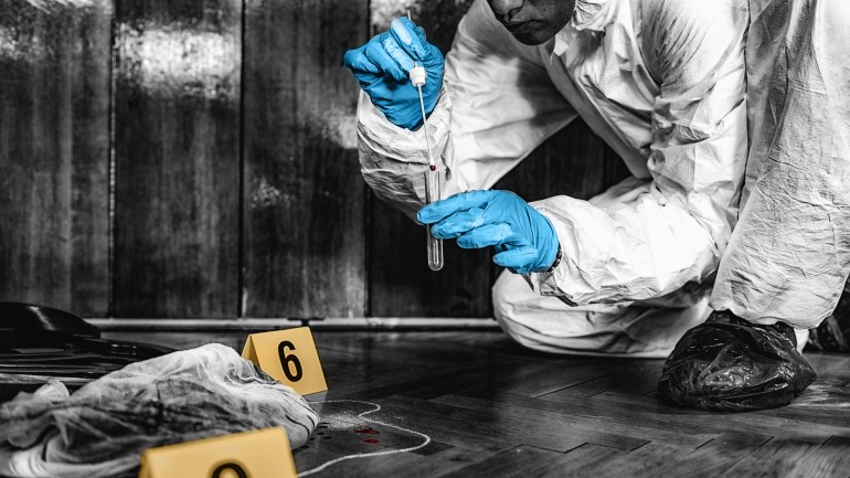 Forensic Investigator collecting blood evidence from a crime scene