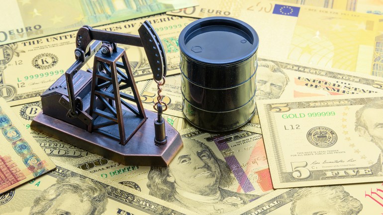 Petroleum, petrodollar and crude oil concept : Pump jack and a black barrel on US USD dollar notes, depicts the money received or earned from sales after investment in the development of oil industry.