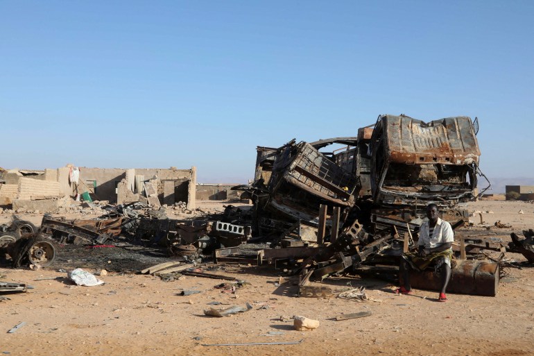 A man sits beside the wreckages of burnt military supply vehicles used by suspected ISIS fighters in Cal Miskaad mountain range in Bari, east of the Gulf of Aden in the city of Bosasso, Puntland region, Somalia January 25, 2025 REUTERS/Feisal Omar TPX IMAGES OF THE DAY