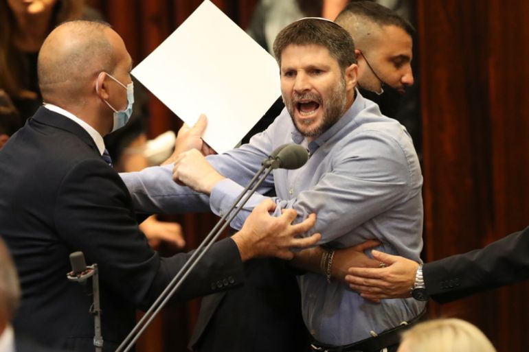 Israeli right wing politician Betzalel Smotrich shouts during a Knesset session in Jerusalem Sunday, June 13, 2021. Naftali Bennett is expected later Sunday to be sworn in as the country's new prime minister, ending Prime Minister Benjamin Netanyahu's 12-year rule. (AP Photo/Ariel Schalit)