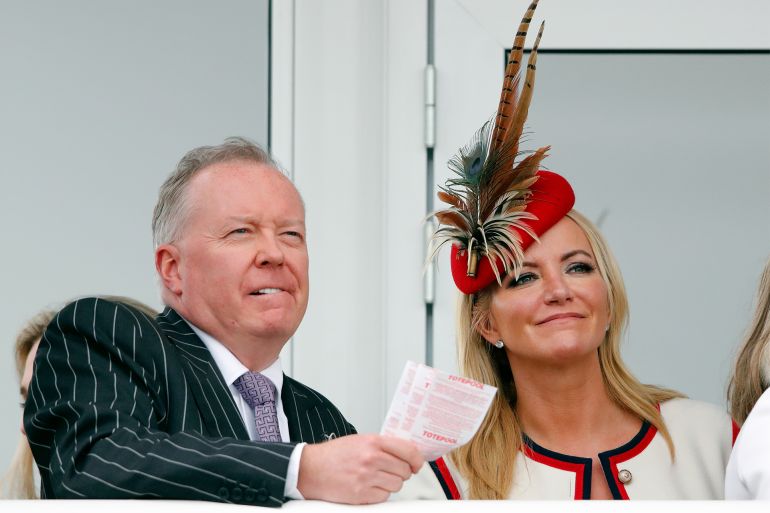 CHELTENHAM, UNITED KINGDOM - MARCH 15: (EMBARGOED FOR PUBLICATION IN UK NEWSPAPERS UNTIL 24 HOURS AFTER CREATE DATE AND TIME) Doug Barrowman and Baroness Michelle Mone watch the racing as they attend day 4 'Gold Cup Day' of the Cheltenham Festival at Cheltenham Racecourse on March 15, 2019 in Cheltenham, England. (Photo by Max Mumby/Indigo/Getty Images)