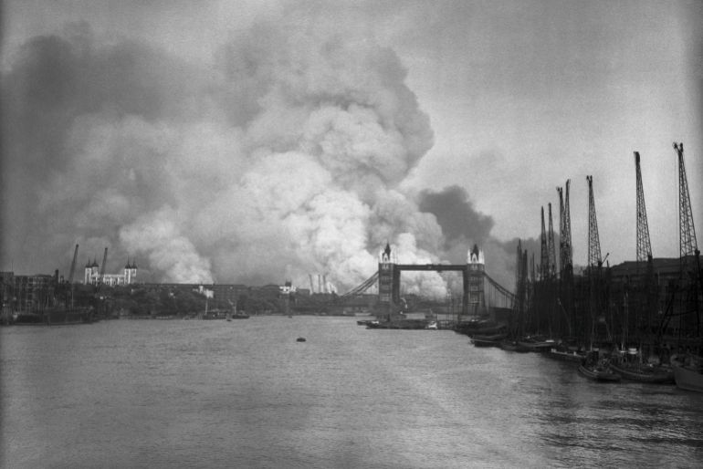 A view east down the Thames towards smoke rising from fires in Surrey docks, following the first German air raid of the London Blitz, 7th September 1940. On the left is the Tower of London, and on the right is Tower Bridge. (Photo by Keystone/Hulton Archive/Getty Images)