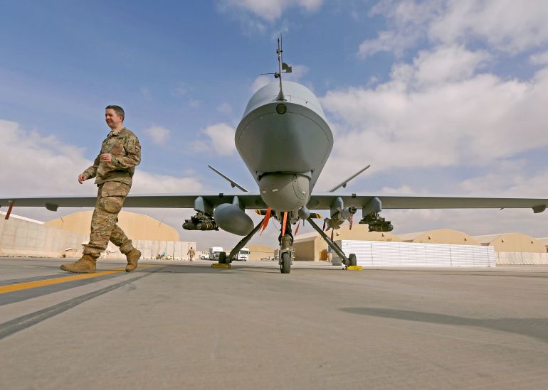 U.S. service member passes in front of a MQ-9 Reaper drone, one of a squadron that has arrived to step up the fight against the Taliban, at the Kandahar air base, Afghanistan January 23, 2018. REUTERS/Omar Sobhani