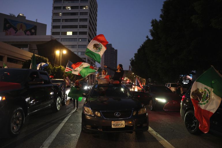 epa12167402 Protestors wave Mexican flags during protests sparked by immigration raids in Los Angeles, California, USA, 09 June 2025. US President Donald Trump has deployed 2,000 National Guard troops, despite not receiving a request from the state of California for any additional assistance, following large protests against ongoing immigration enforcement raids in the Los Angeles area over the last couple of days. EPA-EFE/ALLISON DINNER