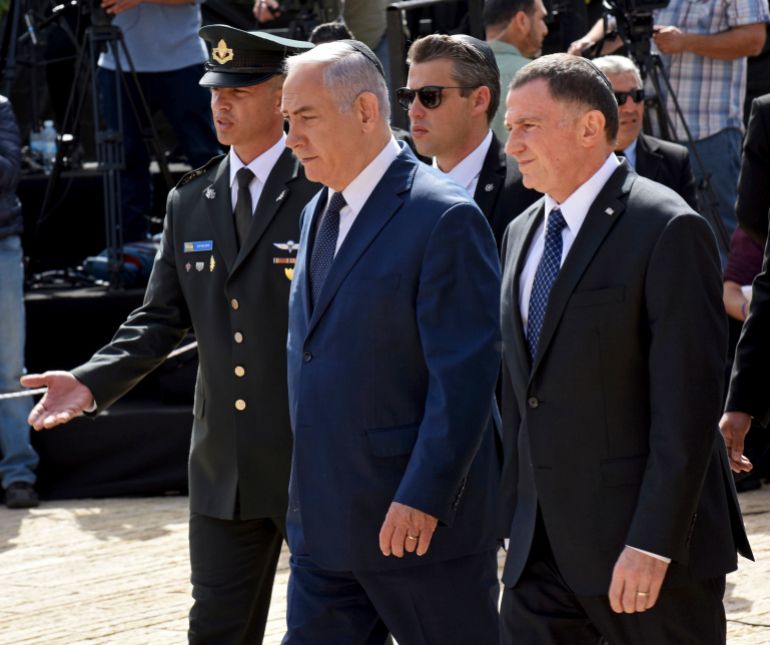 Israeli Prime Minister Benjamin Netanyahu, center, and Knesset Speaker Yuli Edelstein, right, arrive to a ceremony marking the annual Holocaust Remembrance Day at Yad Vashem Holocaust Memorial in Jerusalem, Thursday, April 12, 2018. The somber day is the national memorial for the 6 million Jews killed by Nazi Germany and its collaborators in World War Two. (Debbie Hill/Pool via AP)