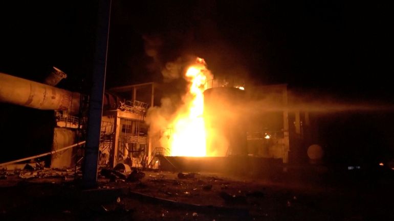 Water canon is being used on fire, as huge fires erupted at a cement factory in Yemen after the Israeli military said it carried out airstrikes against Hodeidah Port and its vicinity, a day after the Iran-aligned Houthis fired a missile that struck near Israel's main airport, at Bajil District, Hodeidah Governate, Yemen, May 5, 2025, in this screengrab obtained from a handout video. AL-MASIRAH TV/Handout via REUTERS THIS IMAGE HAS BEEN SUPPLIED BY A THIRD PARTY NO RESALES. NO ARCHIVES.